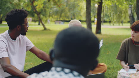 Female-Teacher-Giving-Lesson-to-College-Students-in-Park