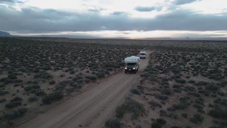 vanlife concept - camper vehicles driving through desert in utah, usa