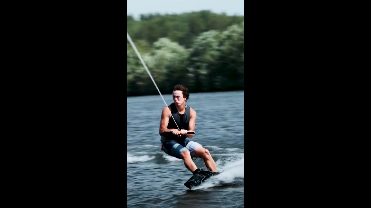 Young Man Wakeboarding on a Lake