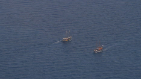 two small excursion tourist boats cross paths in the aegean sea