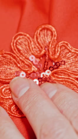 working with pattern in close up. close up view of female seamstress sewing cloth in workshop vertical video