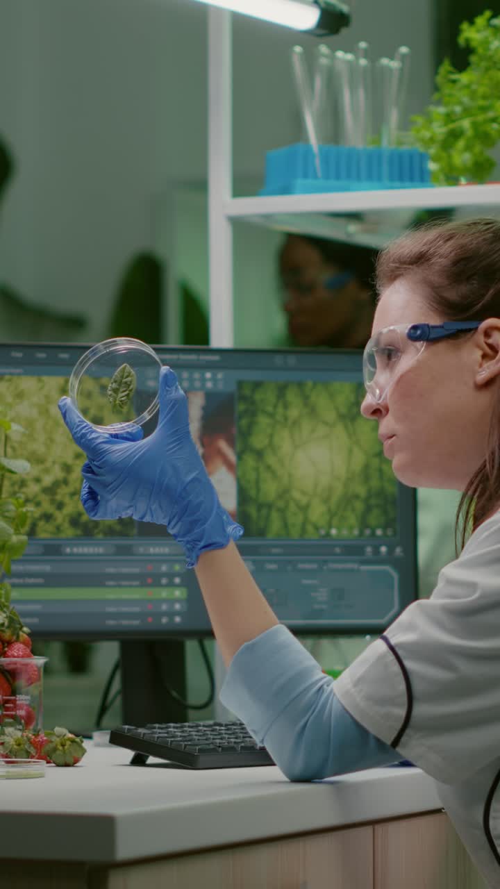 Female scientist analyzing plant sample in a modern laboratory