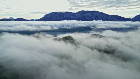 attersee lake with morning mist over the water and surrounding green hills