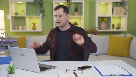 Happy-and-dancing-man-coming-to-his-desk-and-getting-to-work.