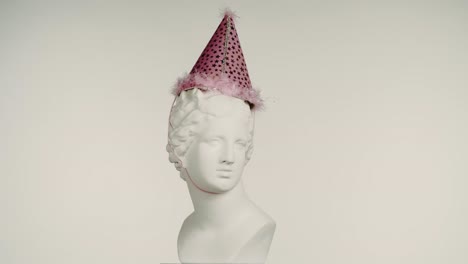 party hat on a marble bust