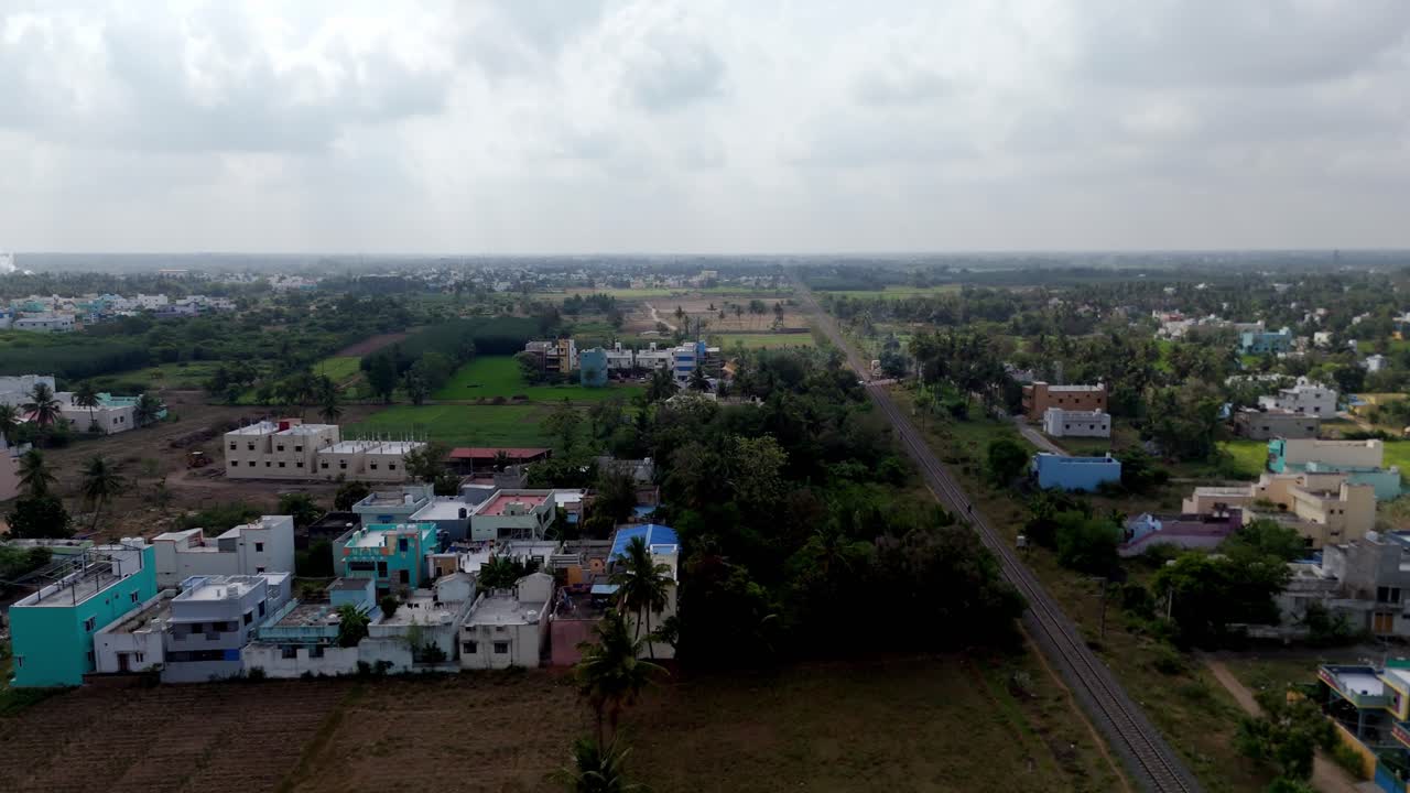 Endless green fields, water bodies, and rural homes viewed from above