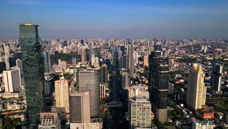 drone shot skyline of bangkok city, skyscrapers, mahanakhon tower, business district, traffic busy streets