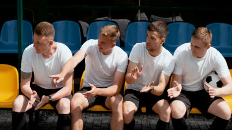 Excited-Street-Football-Players-Sitting-On-Bench-And-Cheering