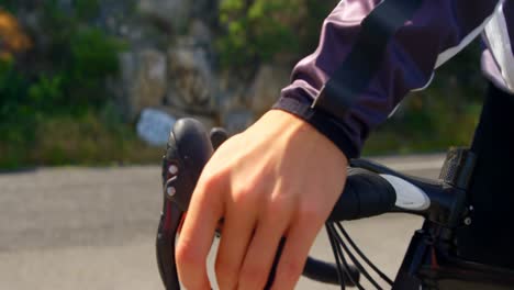 female cyclist ready for cycling on countryside road 4k