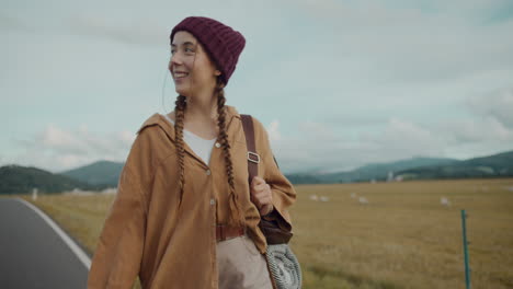 woman with braided hair walking under cloudy sky