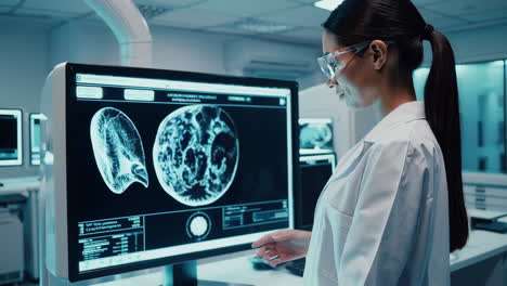 medical professional reviewing medical images on a large monitor.