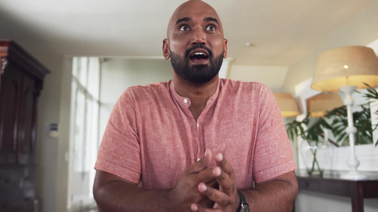 Happy biracial man making video call at home