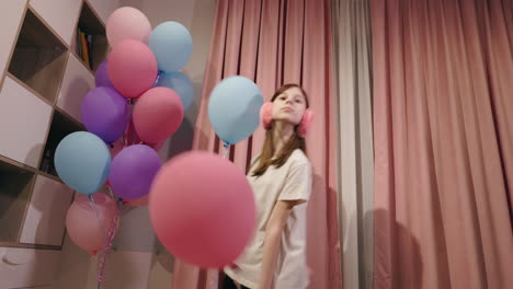 girl dancing with balloons at a party