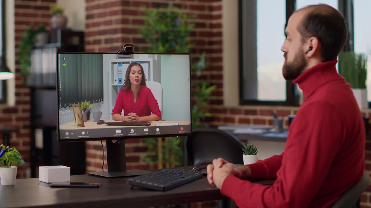 Male employee attending remote videocall meeting