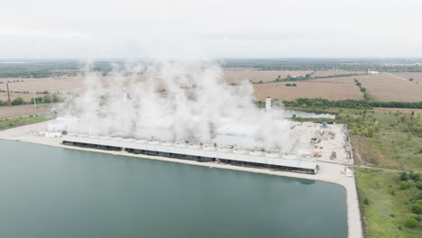 natural gas power plant near a cooling pond in the countryside, aerial view