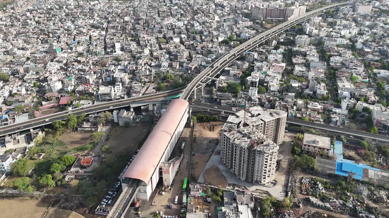 Daytime aerial showing organized traffic, green spaces, and wide roads in Jaipur