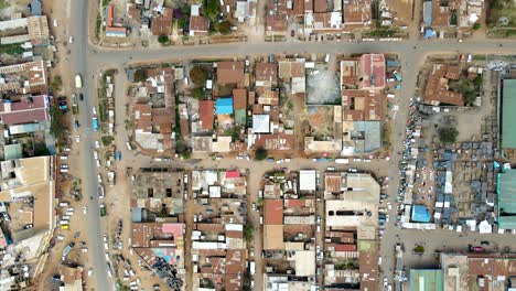 Aerial-flyover-poor-Kibera-Slum-and-modern-skyline-of-Nairobi-in-background-during-sunny-day