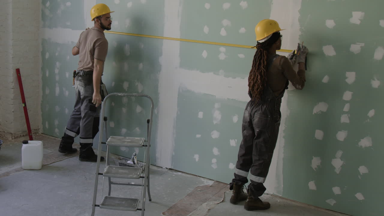 Construction Workers Installing Drywall