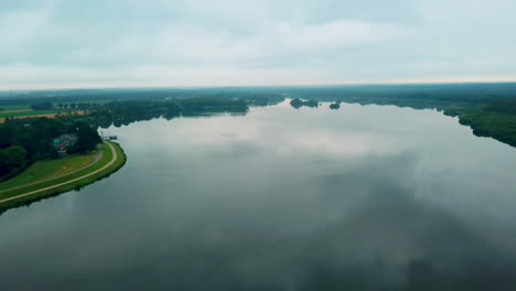 Thülsfelder-lake-near-dam-with-cloudy-landscape-slow-moving-drone-footage-4K