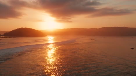 sunrise at the surf spots of gerupuk in lombok, with a view on the bay with the fishing boats and surfers