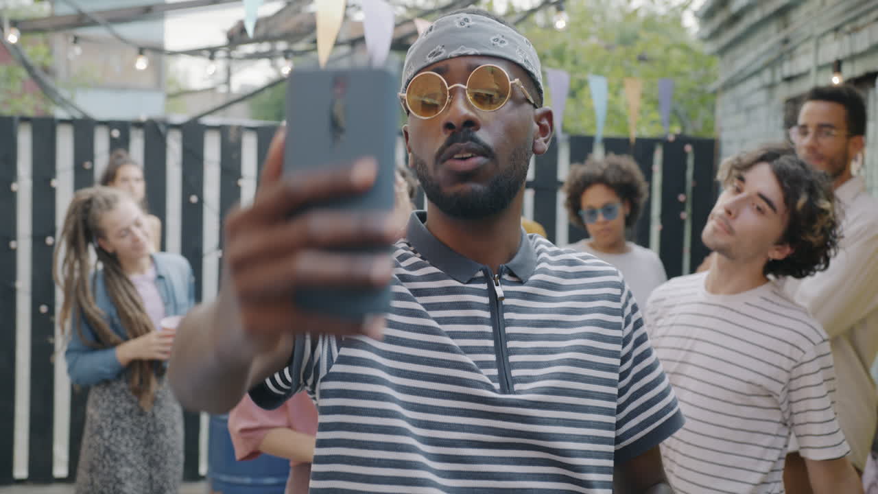 Friends taking selfie at a backyard party