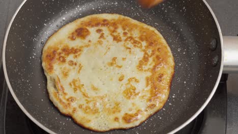 flipping, evenly cooked and golden-brown surface on both sides of the pancake