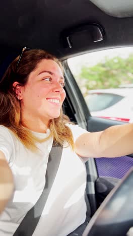 a woman is driving a car and taking a selfie