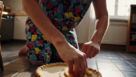 woman baking apple pie in kitchen