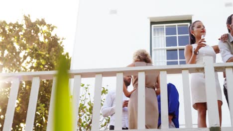 couple interacting while having champange in balcony