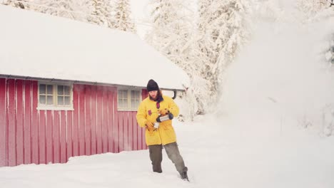 A-Man-Is-Throwing-Hot-Water-Out-Of-The-Freezing-Air