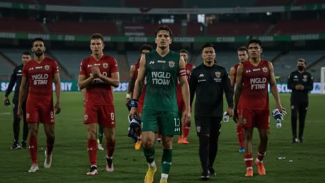 a moment of reflection: players departing the field after an intense match, showcasing emotion and team spirit in a team-worn environment