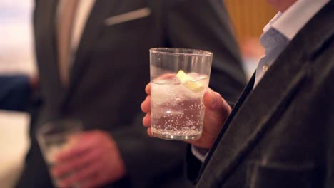 drinking a cocktail at an corporate event