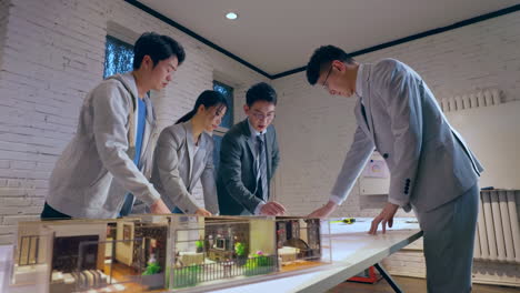 discussion with business team including real estate professionals architects and financial experts gathering around a table to discuss and plan a new real estate development project