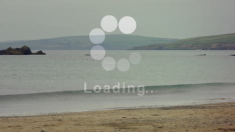 loading animation over beach scene with waves and distant island