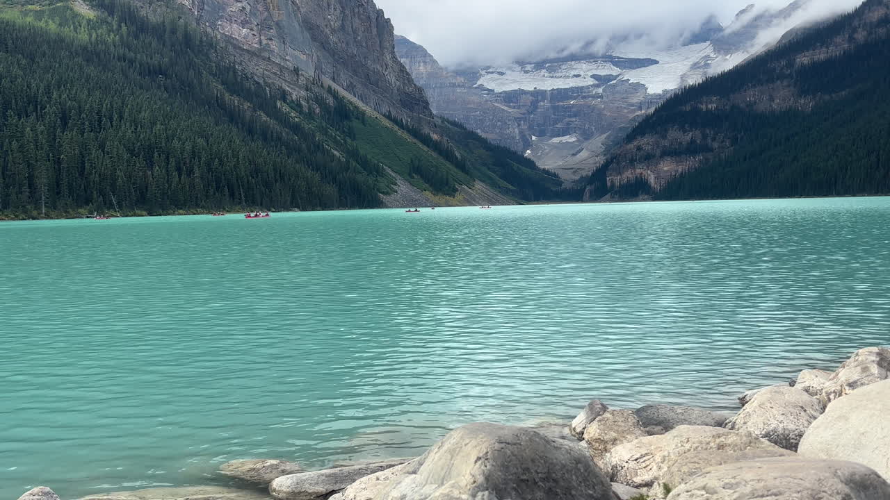 Lake Louise and its turquoise waters against mountainous backdrop. Static
