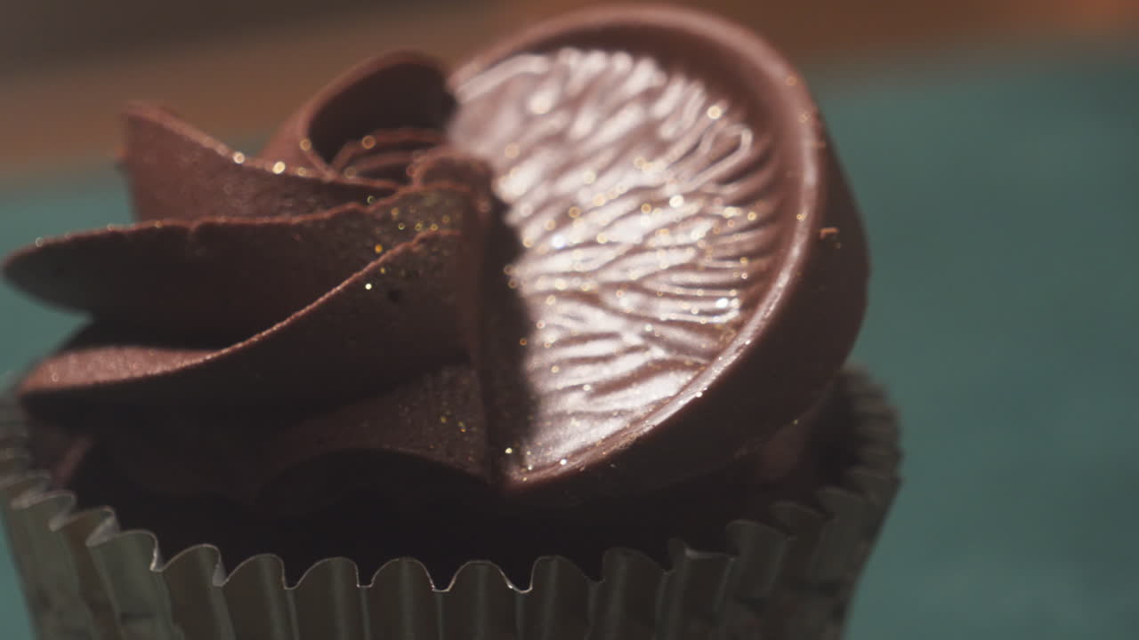 Panning to Delicate Chocolate Orange Cupcake with Frosting. Close Up Snack Dessert Food Photography