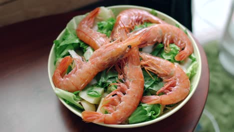 a plate of tasty and healthy seafood salad on top of a wooden table in tokyo, japan. - high angle shot