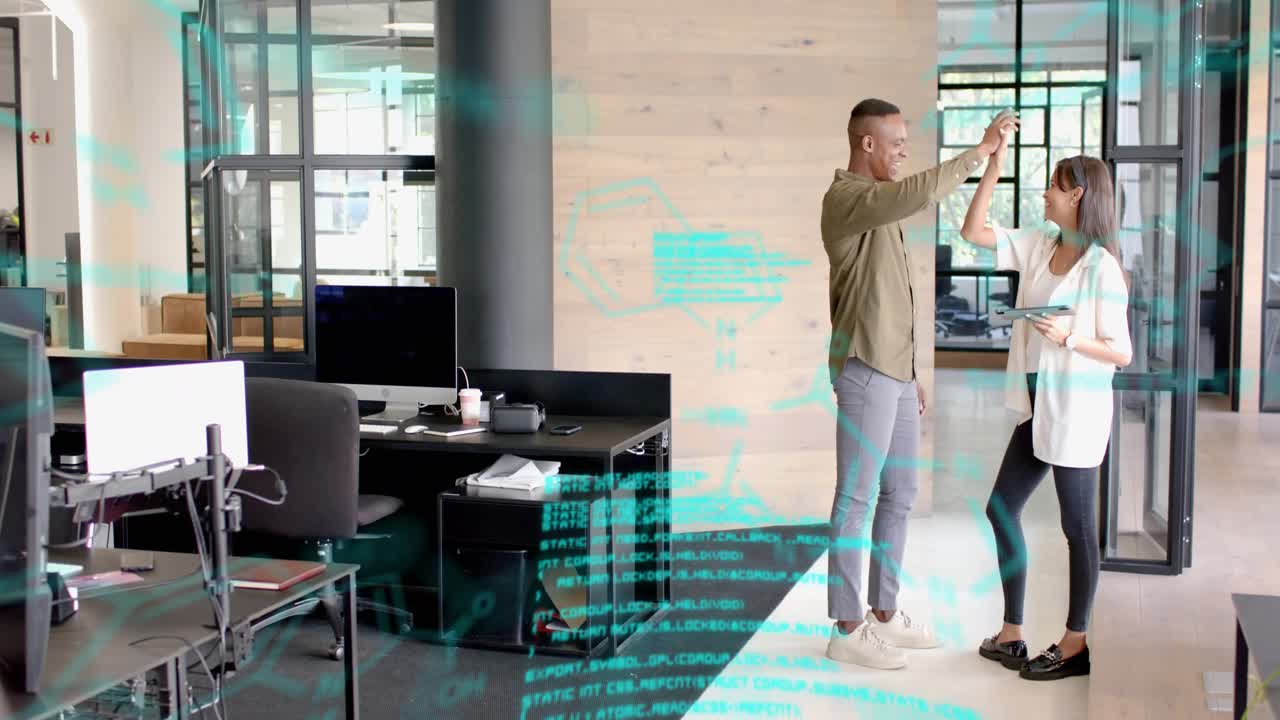 Woman gesturing at tablet, speaking, man high-fiving as AR overlay annotating design in tech review