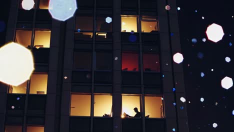 cityscape at night with people working