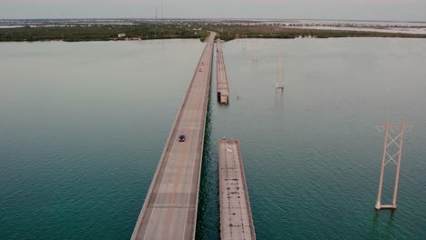 Aerial-shot-of-the-Florida-Keys-Bridge-during-sunset-colorful-skies