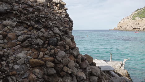 reveal of tropical sea with finger of god rock in ibiza