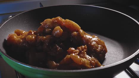 putting seasoned chicken breast into hot pan for frying