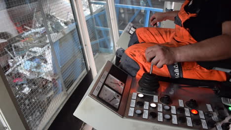 an employee loading scrap metal loading in to a shredder