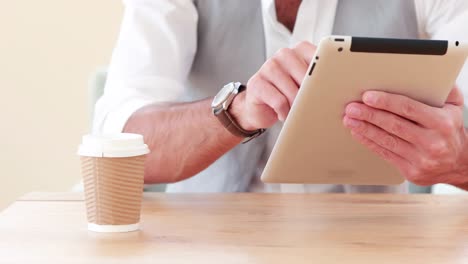 un empresario hipster sonriente usando su tableta
