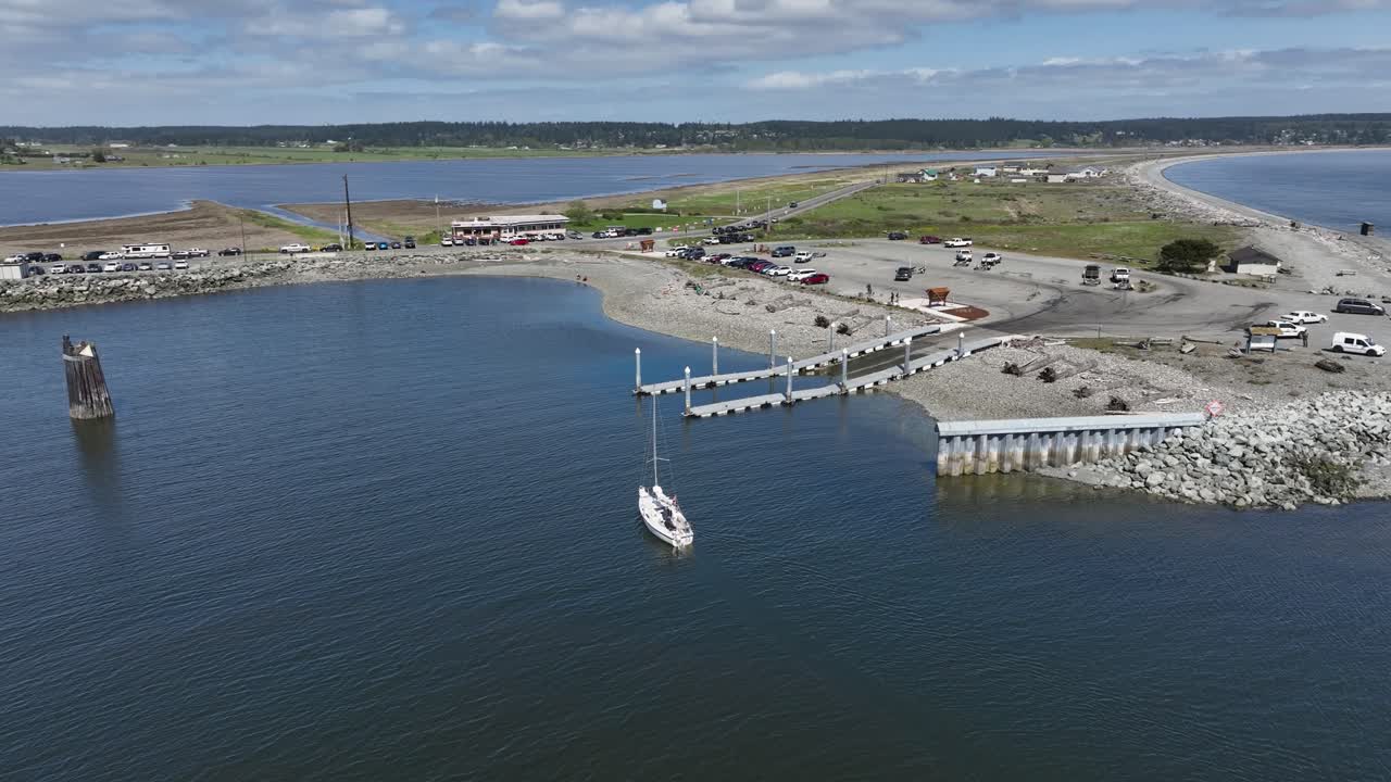 Aerial view of a lone sailboat pulling into the Keystone boat launch in Washington State.