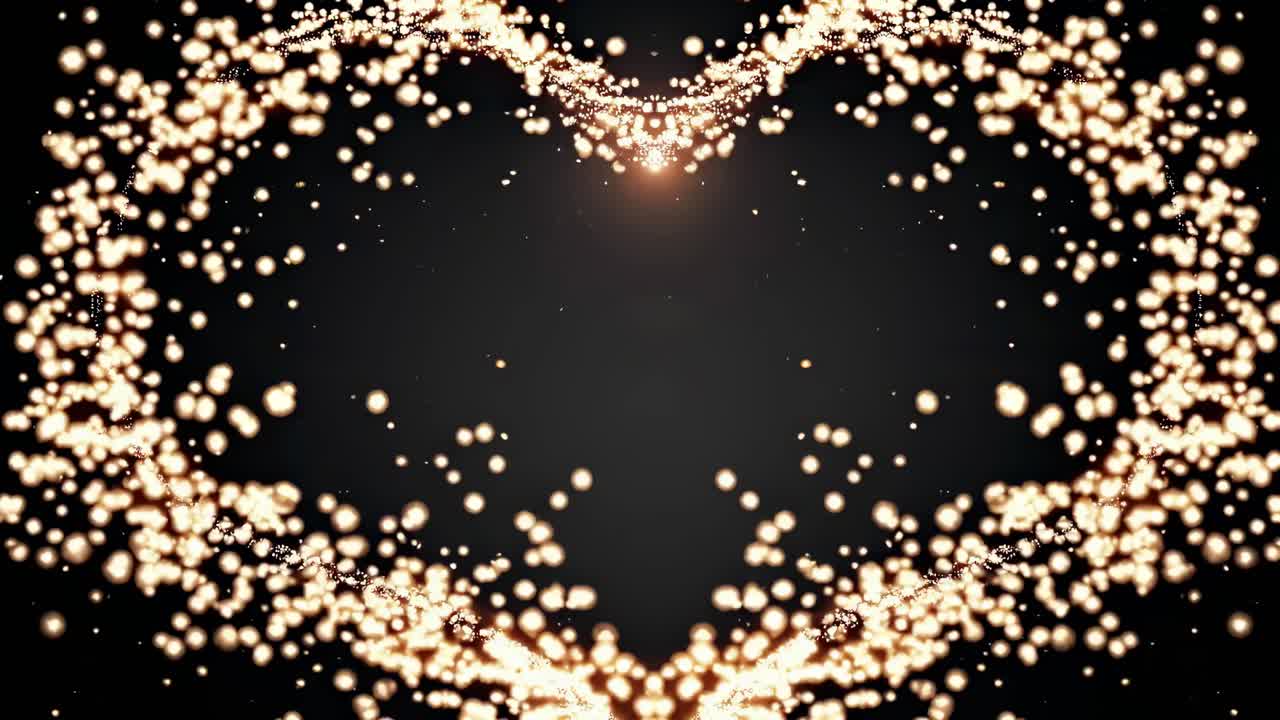 Aerial view of glowing particles forming a heart shape against a dark background