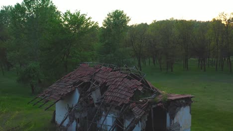 drone footage from old abandoned ruins of a cottage house in the nature, hungary europe drone goes up and flies over the cottage