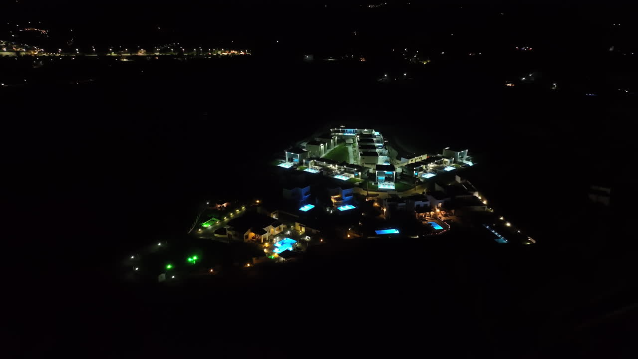 Aerial view orbiting a illuminated holiday resort, night in Rhodes, Greece