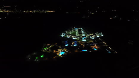 aerial view orbiting a illuminated holiday resort, night in rhodes, greece