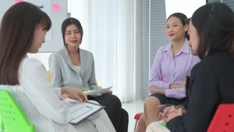 business people proficiently discuss work project while sitting in circle